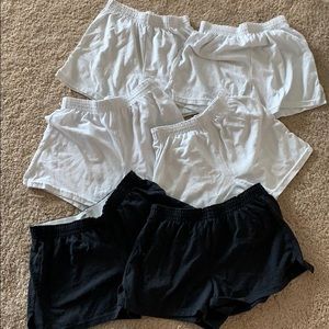 two black soffe shorts and four white